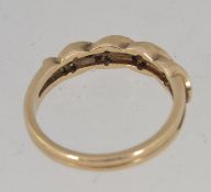 A 9ct gold hallmarked ring with pierced shoulders with channel set diamonds in a rope twist setting.