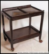 A Chinese metamorphic hardwood mid century butlery serving trolley.