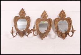 A set of 3 20th century gilt framed oval wall mirrors,