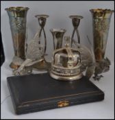 A collection of silver plate items to include a pair of matchin g vases in relief, candle sticks,