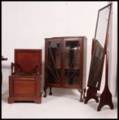A Victorian mahogany box commode with hinged top and lift up elbow rests together with a mahogany