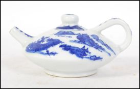 A Chinese blue and white yi-xing teapot in the Kang-xi style complete with the lid having blue