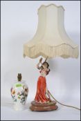 A 20th century Capodimonte lamp depicting a young lady with shade along with a Portmeirion Botanic