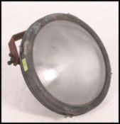 A vintage 20th century maritime copper search light, having a large adjustable bracket to the rear.