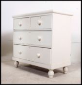 A Victorian painted pine 2 over 3 cottage chest of drawers being raised on bun feet with knob