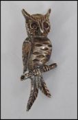 A decorative vintage ladies costume jewellery brooch in the form of an owl upon a branch