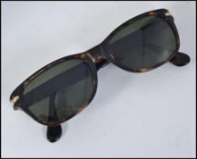 A pair of original Giorgio Armani sunglasses with monogram etching to the lenses complete in the