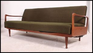 A 1970's original teak Danish influence sofa day bed in the manner of Scandart.