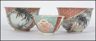 A pair of Japanese early 20th century porcelain tea bowls with character marks to the base along