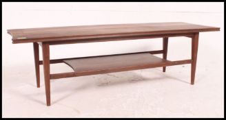 A vintage / retro 1970's Danish Influence solid teak coffee table raised on shaped legs with