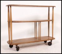 An early 1960's / 1970's Ercol beech and elm low room divider raised on the original wheel castors
