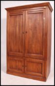 A 20th century American made Eathan Allen linen press / wardrobe having two long doors above two