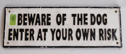 A cast iron black and white ' Beware Of The Dog ' wall sign. 40cm long.