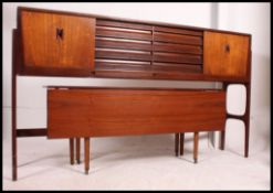A 1970's Danish teak raised sideboard / dresser dining table combination.