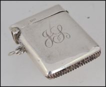 A silver hallmarked vesta case with monogram to centre.