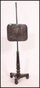 A 19th century Regency pole screen having black laquered finish with chinoserie decoration raised