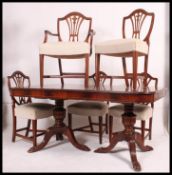 A good quality Georgian revival large mahogany inlaid extending dining table raised on pedestal