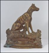 An early 20th century Sportsman's Friend brass doorstop in the form of a greyhound entitled