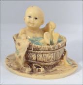 An unusual Chinese Okimono type figurine / diorama of a child in a bath H8cm