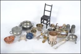 A collection of pewter items to include condiments, also flatwares,