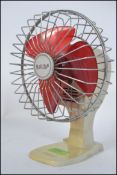 A vintage retro Rallifan miniature desktop electric fan. With original red blades.