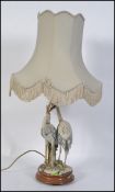A 20th century Capodimonte table lamp depicting a pair of storks / Herons on a naturalistic base