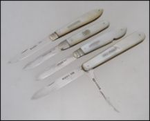 A collection of 4 silver mother of pearl hallmarked fruit knives - pen knives.