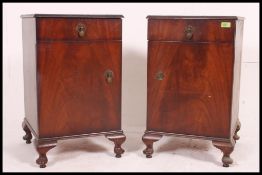 A true pair of mid 20th century bedside cabinets, each with a single drawer above a door,
