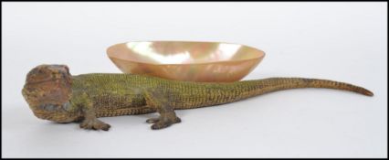 A stunning early 20th Century cast metal cold painted model of a lizard,