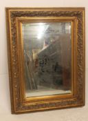 A large antique Victorian style gilt overmantel mirror dating to the 20th century having central