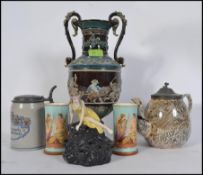 A collection of ceramics to include a twin handled bulbous vase raised in relief,