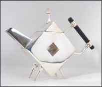 A silver plated teapot in the manner of Christopher Dresser having angular form, pierced centre.