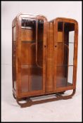 A 1930's Art Deco drop centre walnut china display cabinet.