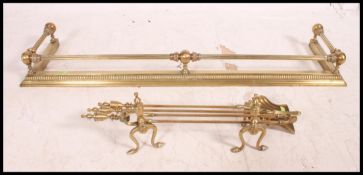 A good quality fire side compendium set along with a brass fret wok fire fender and brass fire dogs.