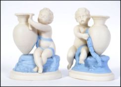 A pair of early Royal Worcester white glazed figural candle sticks.
