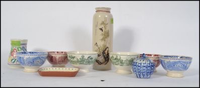 A vintage 20th century Poole pottery vase together with a Torquay ware / mottoware dish,
