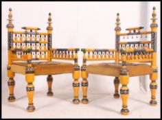 A stunning pair of Indian handpainted yellow opium / hall chairs raised on turned legs with
