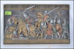 A mid 20th century painted plaster plaqu