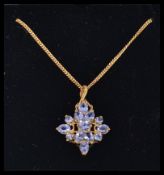 A 9ct gold and tanzanite ladies pendant and 9ct gold necklace chain.