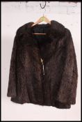 A vintage hip length dark brown fur coat