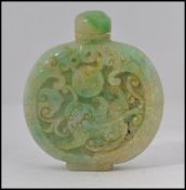 A Chinese green jade perfume bottle / moon flask with carved relief designs to the sides complete