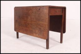 A 19th century country oak drop leaf din