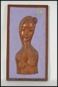 A retro 1970's teak wood carving of a ma