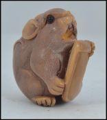 A Chinese well carved mouse sat on a tag