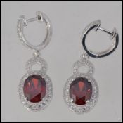 A pair of ladies silver Cz and garnet ad