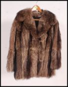 A vintage 3/4 length believed to be Wolf fur coat, having a black satin lining,