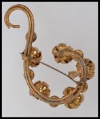 A 1940's gold tone brooch with set amber