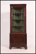 A Georgian mahogany corner cabinet havin