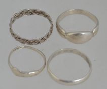 A white metal silver band ring in a wove