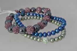 A collection of three shamballa pearl br